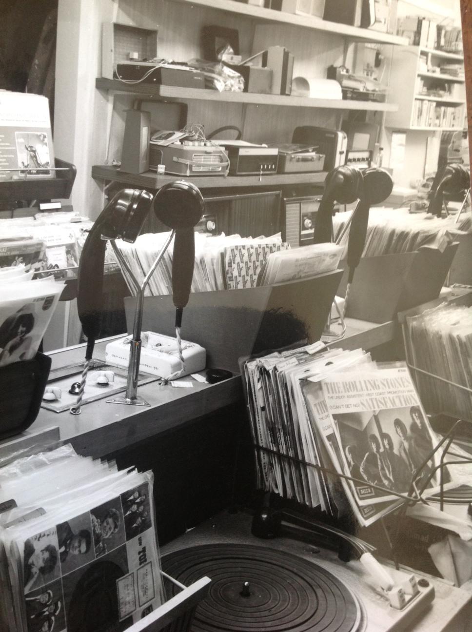 Inside H. v.d. Horst, with listening handsets, a turntable, and rows of records.